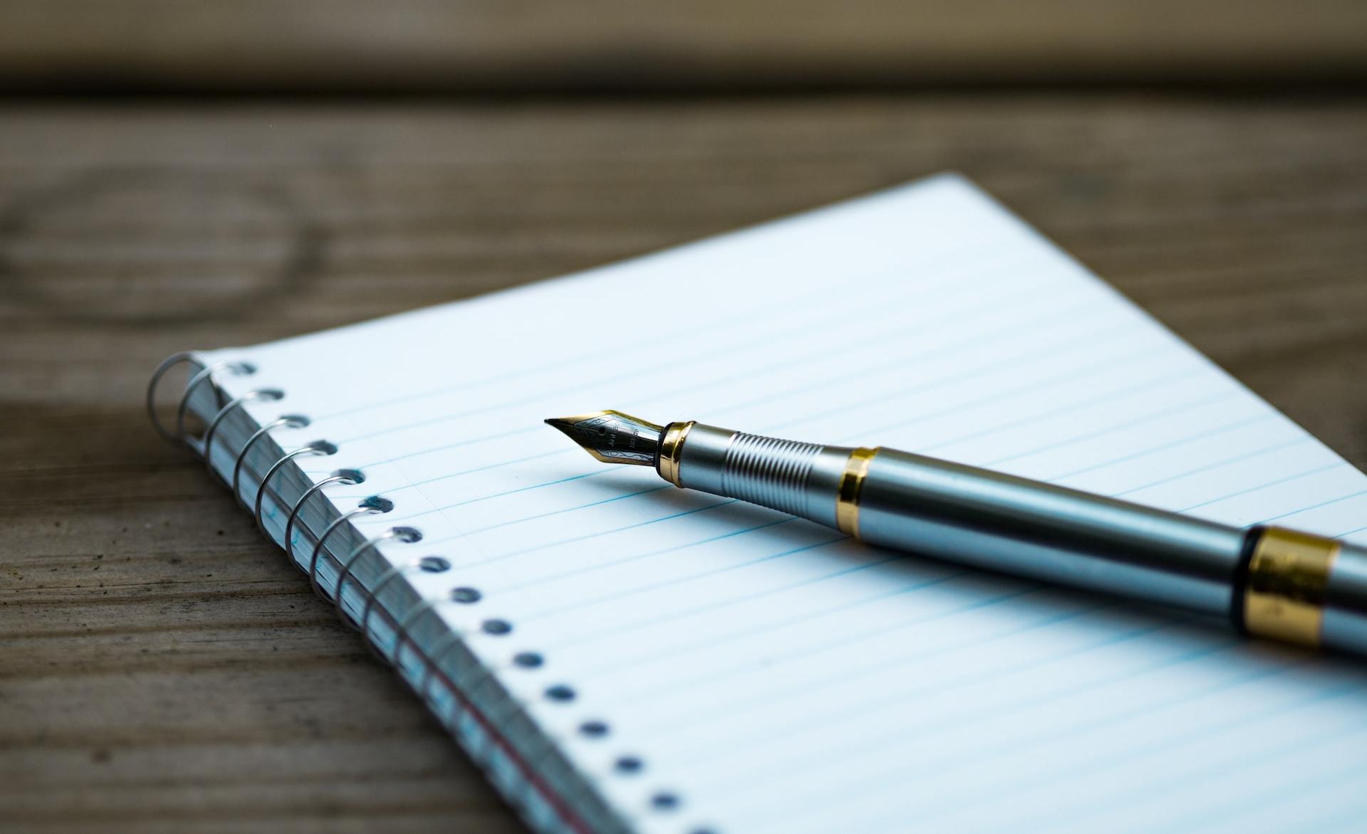 fountain pen on spiral book